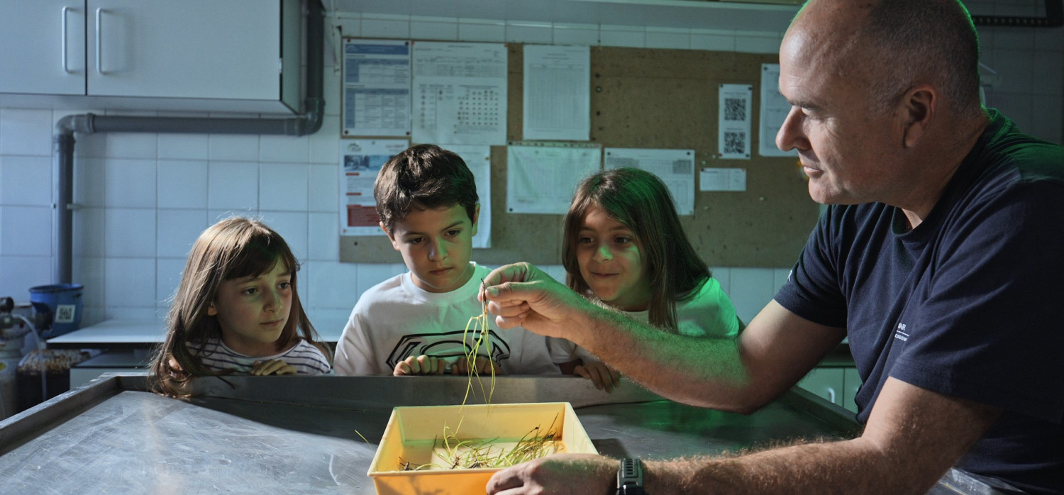 Reasearcher showing samples to kids
