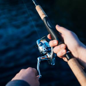 Photo of Person Holding Fishing Rod